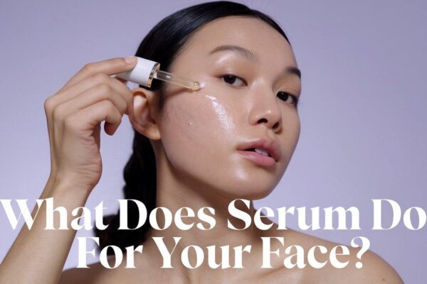 What Does Serum Do for Your Face? A woman applying serum to her cheek with a dropper. | women lux life